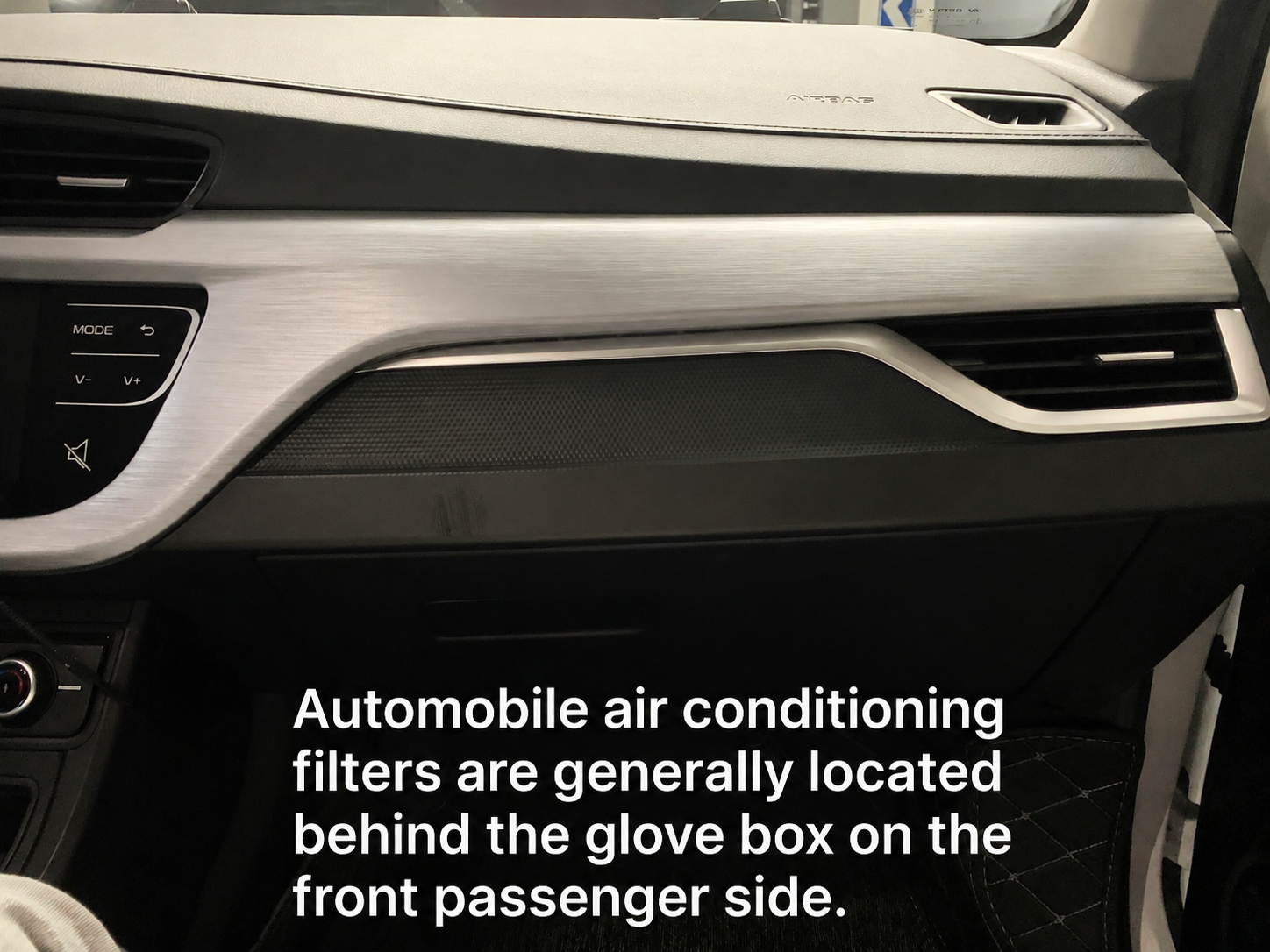 Interior view of a modern car dashboard showing the location of cabin air filter behind the front passenger side glove box area near the HVAC air vents.