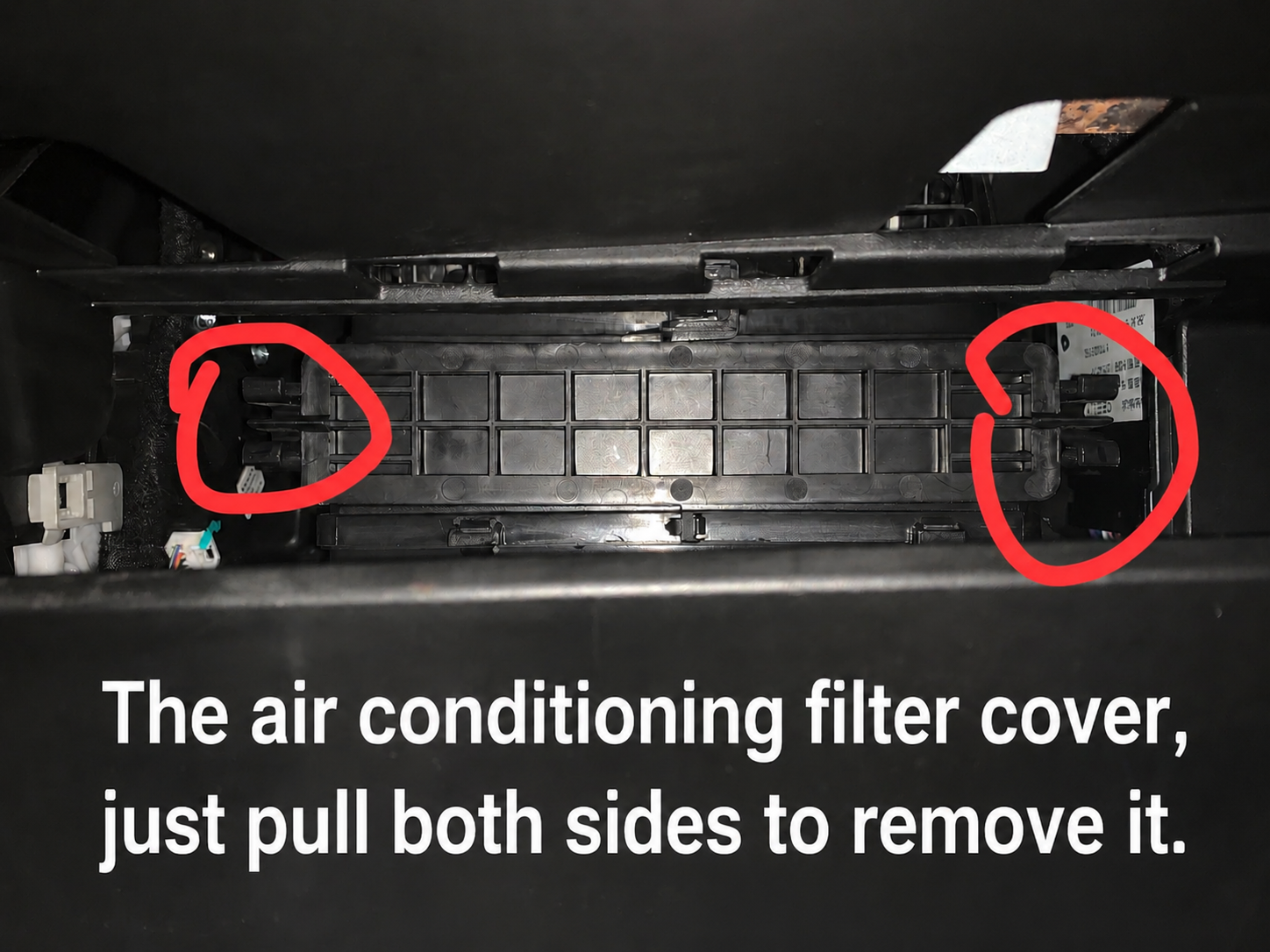 Close-up of the cabin air filter access compartment with left and right release clips highlighted in red circles, showing how to pull both sides to remove the inner filter cover.